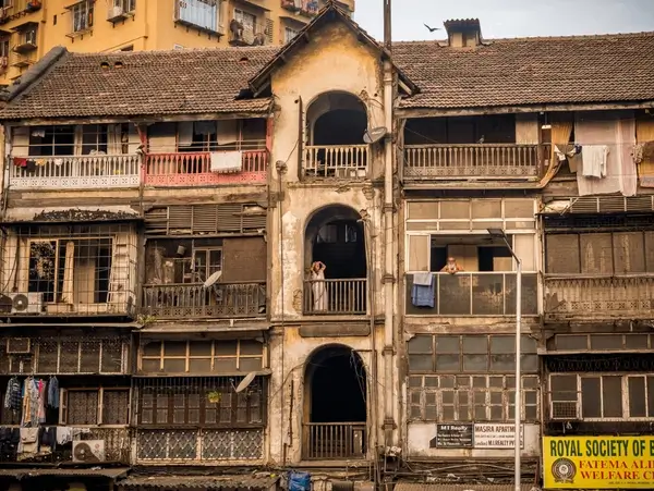 Old residential building in Mira Road showing structural aging and deterioration — a sign that housing society redevelopment may be needed