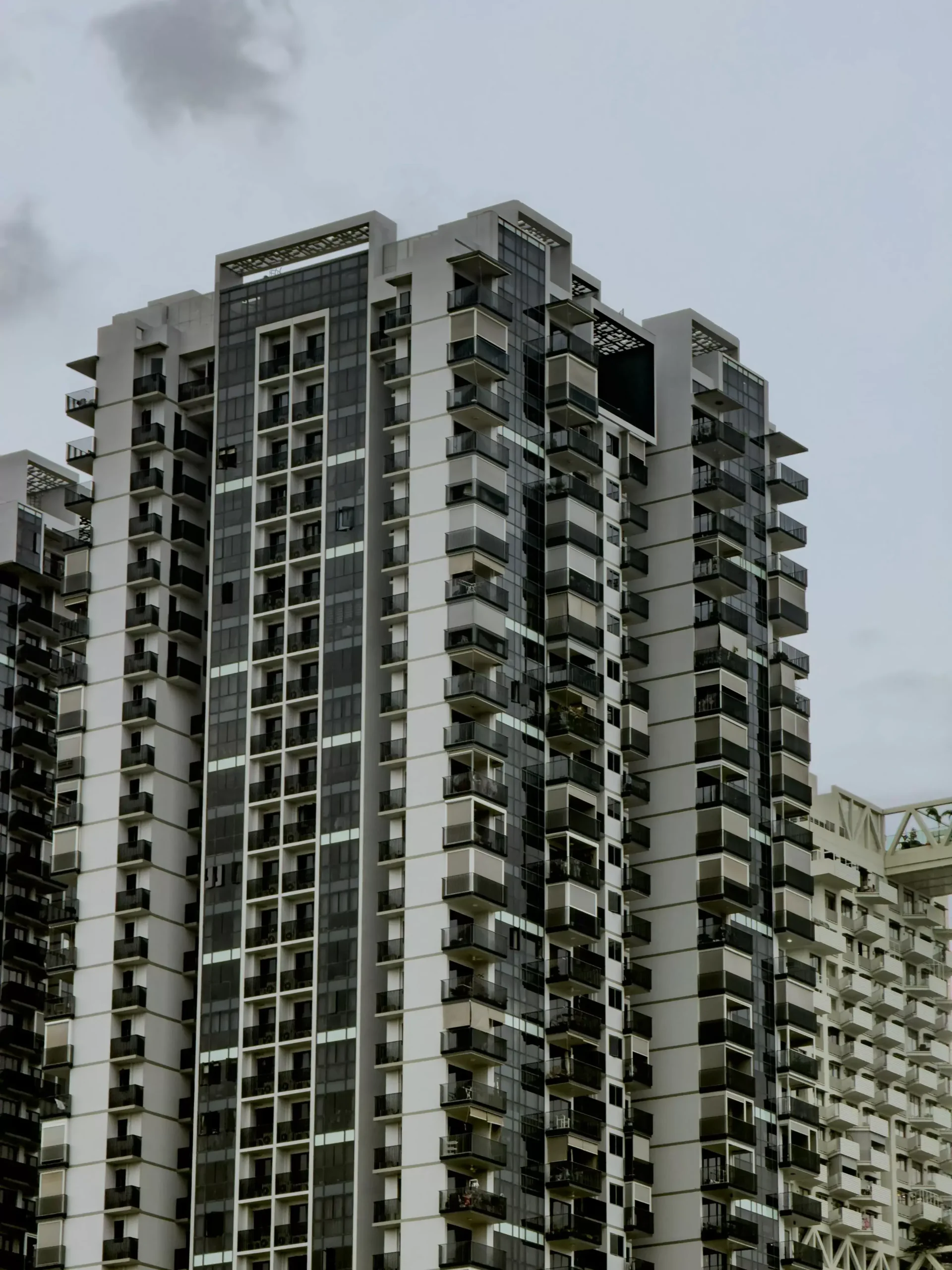 Modern residential apartment building in Mira Road showing upgraded amenities, elevators, and parking — what redevelopment delivers for housing societies
